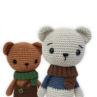 Two amigurumi bears wearing scarves and shorts