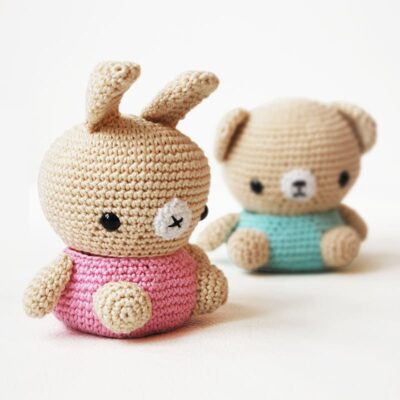 Crochet amigurumi jewelry storage boxes with bear and bunny heads on top.