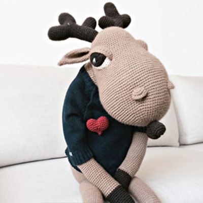 Big crochet moose wearing a crocheted heart pin