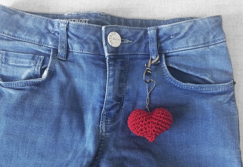 Crochet heart hanging on jeans.