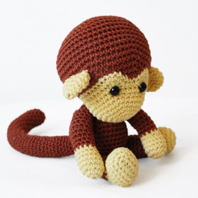 Crochet monkey sitting on the floor