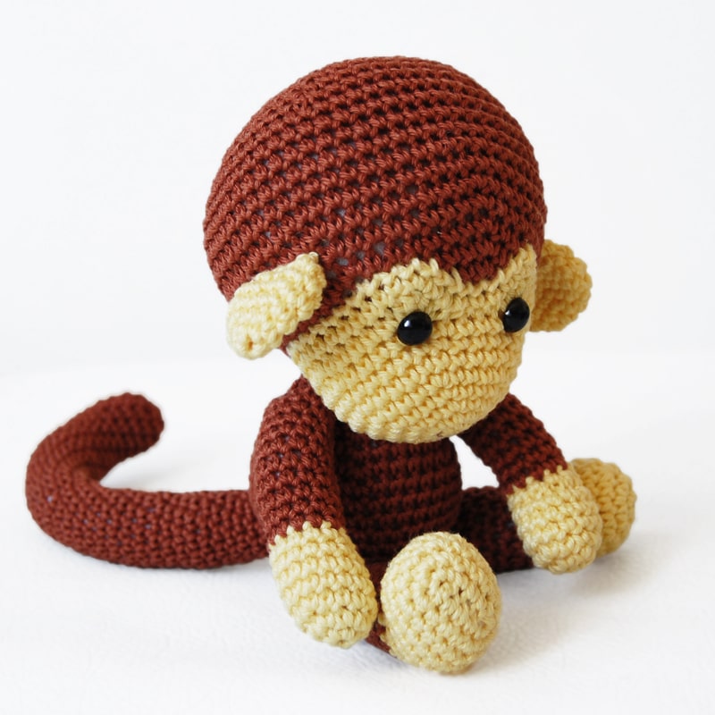 Crochet monkey sitting on the floor