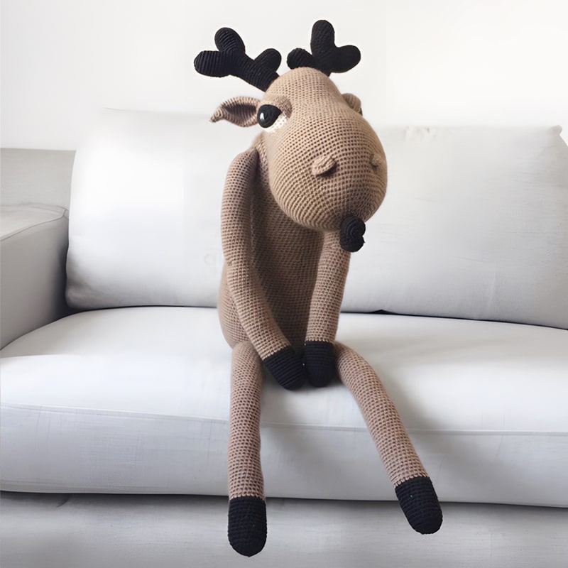 Big crochet moose sitting on the sofa