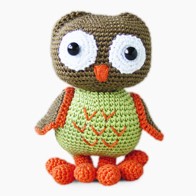 Amigurumi crochet owl made with brown, orange, green, and white yarn, free owl crochet pattern.