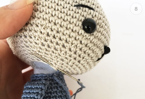 Sewing head to the body - making teddy bear.