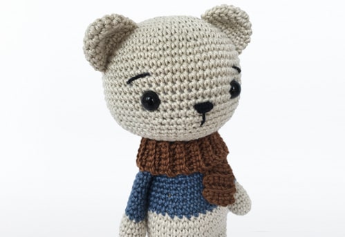 Cute crochet teddy bear completed following this free crochet bear pattern.